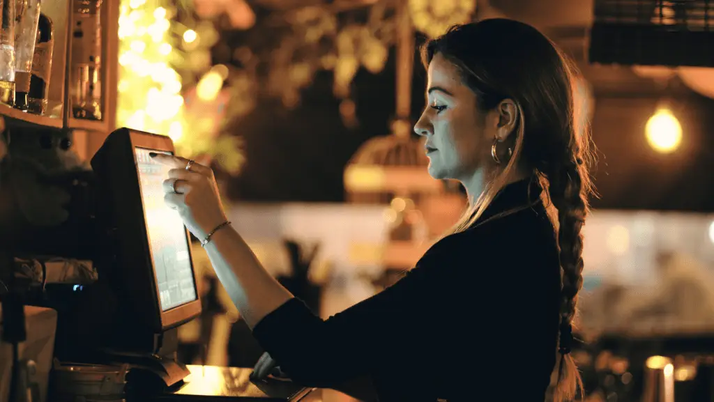 Mitarbeiterin in einer Gastronomie an der Kasse